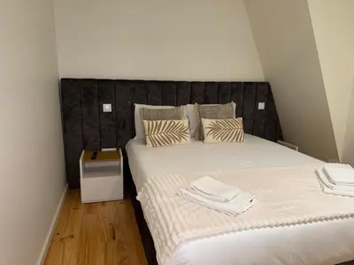 a bedroom with a bed with towels on it at Jardins de Cedofeita Apartment by Oporto Soul in Porto