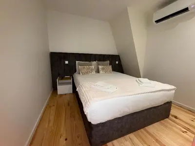 a bedroom with a large bed in a room at Jardins de Cedofeita Apartment by Oporto Soul in Porto