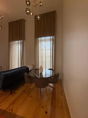 a living room with a glass table and a couch at Jardins de Cedofeita Apartment by Oporto Soul in Porto
