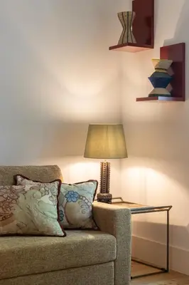 a lamp on a table next to a couch at Luxurious Flat in Award-Winning Building in Porto