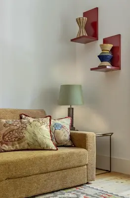 a living room with a couch and a lamp at Luxurious Flat in Award-Winning Building in Porto