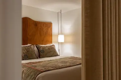 a bedroom with a bed with a headboard and pillows at Luxurious Flat in Award-Winning Building in Porto