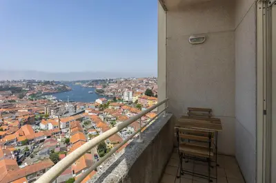 a balcony with two chairs and a view of a city at Liiiving in Gaia - Douro Balcony View in Vila Nova de Gaia