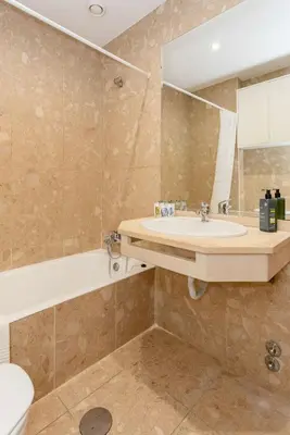 a bathroom with a sink and a tub and a toilet at Liiiving in Gaia - Douro Balcony View in Vila Nova de Gaia