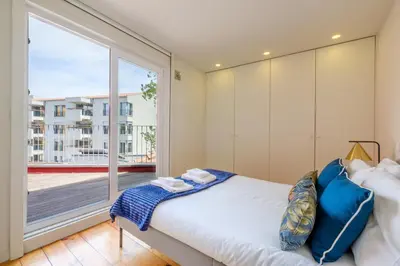 a bedroom with a bed and a large window at Magnolia 5 Luxury with AC Metro Downtown Porto in Porto