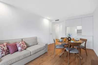 a white side table next to a bed at Porto Style & Comfort | Balcony + Parking in Porto
