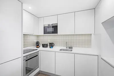 a white living room with a table and a couch at Porto Style & Comfort | Balcony + Parking in Porto