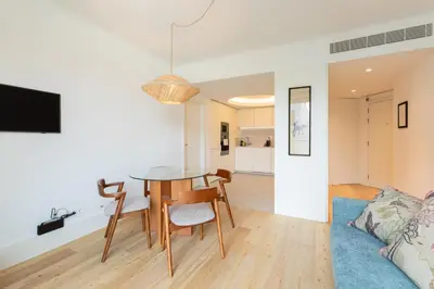 a dining room and living room with a table and chairs at Chic 1-BR Flat in Award-Winning Building in Porto