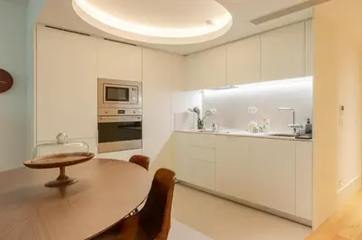 a kitchen with a wooden table and a dining room at Breathtaking Loft in Award-Winning Building in Porto