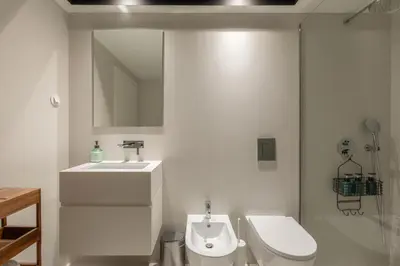 a white bathroom with a sink and a toilet at Breathtaking Loft in Award-Winning Building in Porto