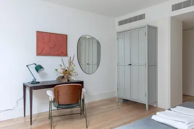 a bedroom with a desk and a mirror at Breathtaking Loft in Award-Winning Building in Porto