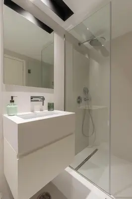 a white bathroom with a sink and a shower at Breathtaking Loft in Award-Winning Building in Porto