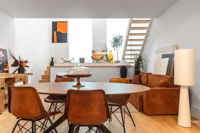 a living room with a table and chairs at Breathtaking Loft in Award-Winning Building in Porto