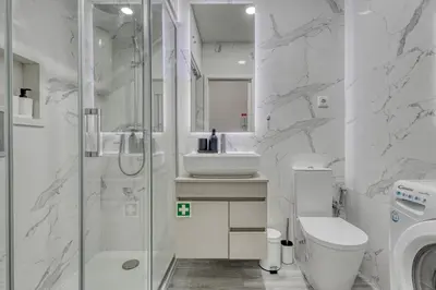 a bathroom with a shower and a toilet and a sink at OPORTO GUEST Marquês Square in Porto