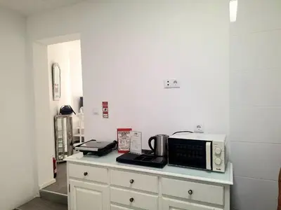 a counter with a microwave and a coffee maker on it at porto true confession in Porto