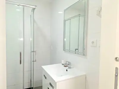 a white bathroom with a sink and a shower at porto true confession in Porto