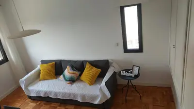 a living room with a couch with yellow pillows at RIVER VIEW TMB oporto station house in Porto