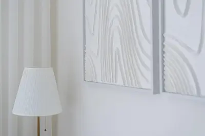 a lamp and a picture on a wall with a lamp and a picture at GuestReady - An elegant stay in the city centre in Porto