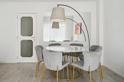 a dining room with a white table and chairs at GuestReady - An elegant stay in the city centre in Porto