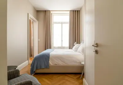 a bedroom with a white bed and a window at Mouzinho 160 in Porto