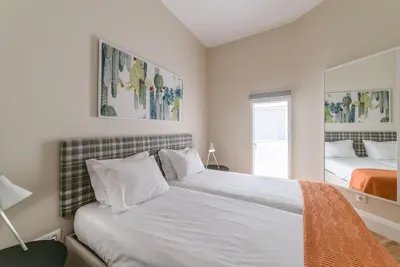 a bedroom with two beds and a window at Mouzinho 160 in Porto