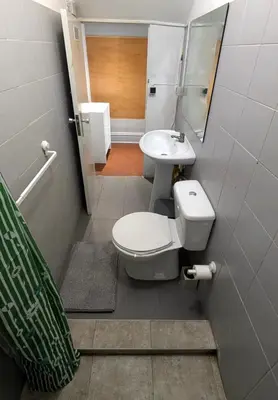 a bathroom with a toilet and a sink at Riko Guesthouse in Porto