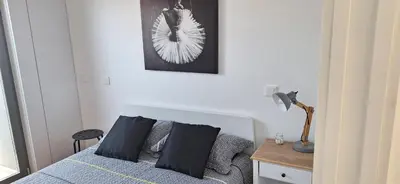 a bedroom with a bed and a table with a lamp at Fontainhas Sunny Rooftop with balcony in Porto