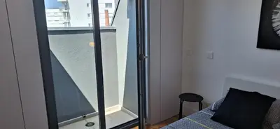 a bedroom with a glass window and a bed with a bed gmaxwell gmaxwell gmaxwell gmaxwell at Fontainhas Sunny Rooftop with balcony in Porto