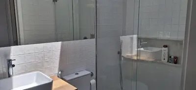 a bathroom with a shower and a toilet and a sink at Fontainhas Sunny Rooftop with balcony in Porto