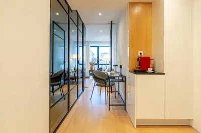 a kitchen with glass doors leading to a dining room at Stylish Flat with Workspace & Garage by HostWise in Porto
