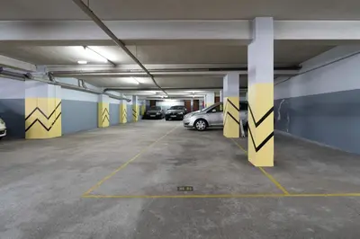 an underground parking garage with cars parked in it at Stylish Flat with Workspace & Garage by HostWise in Porto