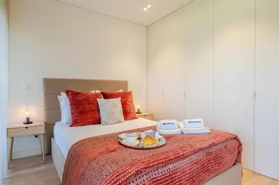 a bedroom with a bed with a tray of food on it at Studio w/ Balcony, Pool & Gym in Antas by HostWise in Porto