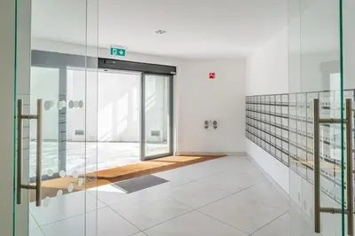 an empty room with glass walls and a staircase at Studio w/ Balcony, Pool & Gym in Antas by HostWise in Porto