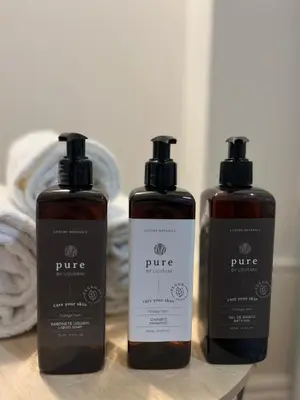 three bottles oficating products sitting on a table at Avantgarde by Upperground in Porto
