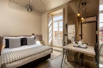 a bedroom with a bed and a table and a window at YOUROPO - Clerigos in Porto