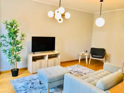 a living room with a couch and a tv at YOUROPO - Clerigos in Porto