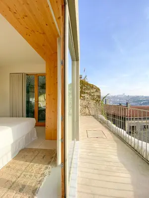 a room with a bed and a balcony with a view at Plunge Pool River Views Apt A Adults Only in Porto