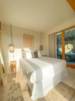 a large white bed in a bedroom with a window at Plunge Pool River Views Apt A Adults Only in Porto