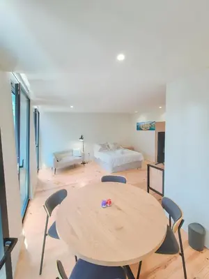 a room with a table and chairs and a bed at Porto Breeze 2 in Porto