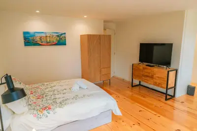 a bedroom with a bed and a flat screen tv at Porto Breeze 2 in Porto