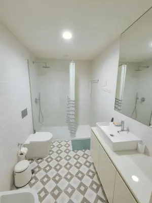 a white bathroom with a toilet and a sink at Porto Breeze 2 in Porto