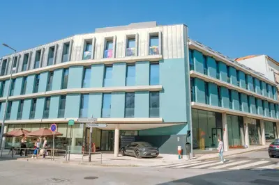 a building on a street with a car parked in front at Porto Breeze 2 in Porto