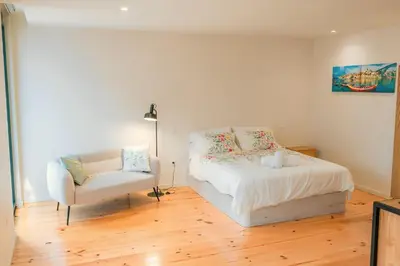 a bedroom with a bed and a chair at Porto Breeze 2 in Porto