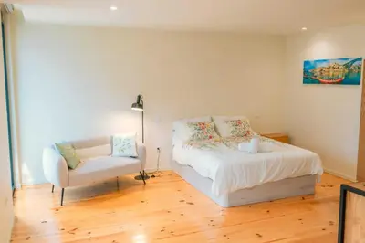 a bedroom with a bed and a chair at Porto Breeze 2 in Porto