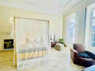a bedroom with a canopy bed in a room at Ai Porto! Books&Roots in Porto