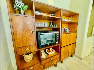 a wooden entertainment center with a television in it at Ai Porto! Books&Roots in Porto