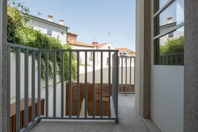 a view from a balcony of a house with a gate at Sao Bento Luxury Hideaway 2 Bedroom Downtown Porto in Porto