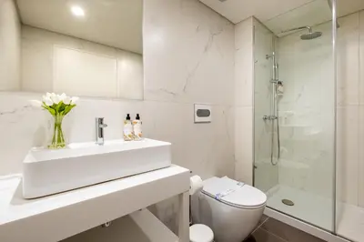 a bathroom with a sink and a toilet and a shower at Sao Bento Luxury Hideaway 2 Bedroom Downtown Porto in Porto