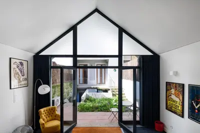 a room with a large window and a yellow chair at Cool Alegria Loft Mezzanine Retreat in Porto