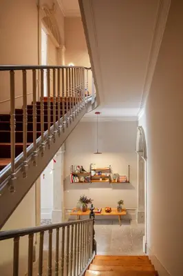 a staircase in a house with a stair case at Baumhaus Serviced Living - Art & Design Apartments in Porto